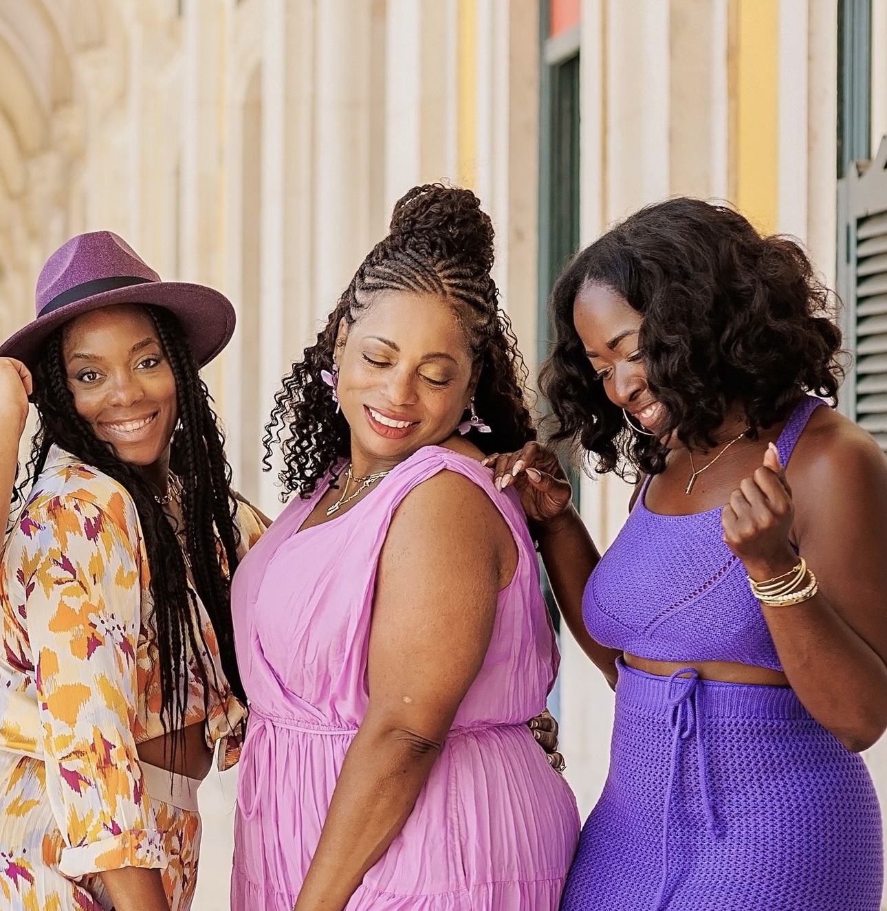 Three women in different outfits posing for a picture.